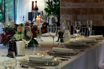 Beautiful table setting, for a holiday. with the dishes .flowers and candles