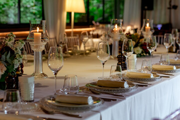 Beautiful table setting, for a holiday. with the dishes .flowers and candles