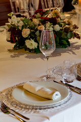 Beautiful table setting, for a holiday. with the dishes .flowers and candles
