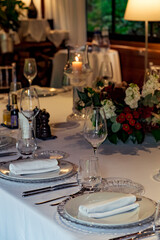 Beautiful table setting, for a holiday. with the dishes .flowers and candles