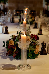 Beautiful table setting, for a holiday. with the dishes .flowers and candles