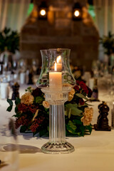 Fototapeta premium Beautiful table setting, for a holiday. with the dishes .flowers and candles
