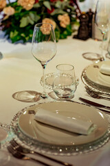 Beautiful table setting, for a holiday. with the dishes .flowers and candles