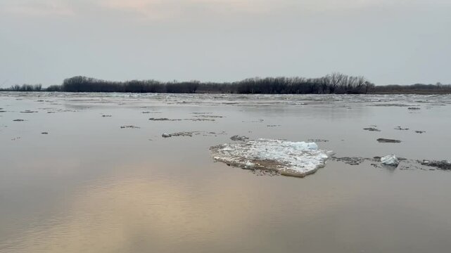 Ice drift on a river in spring during sunset