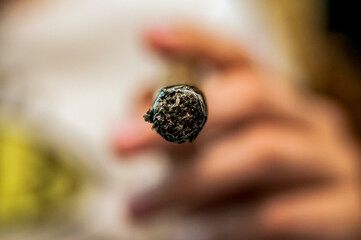 Detail of the hand of a smoking man holding a burning cigar