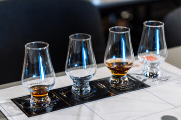 Tasting session with whiskey samples and cocktail preparations at a bar