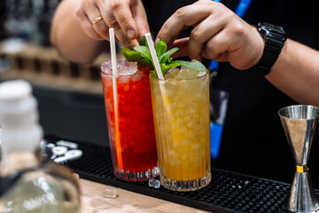Cocktail preparation featuring vibrant drinks at a lively event