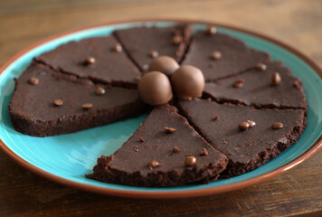 Pralines on top of an chocolate cake on a blue plate