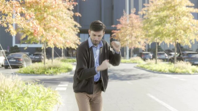 Cheerful Employee Dancing Outside in Business Casual