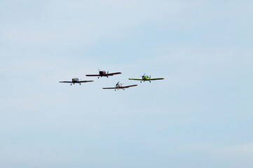 A pilot flies an aerobatic propeller plane in the sky