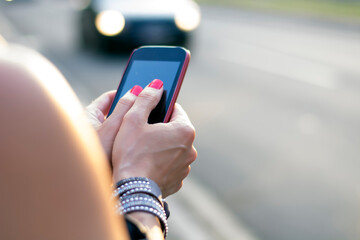 Close up view of business woman typing text message outdoors