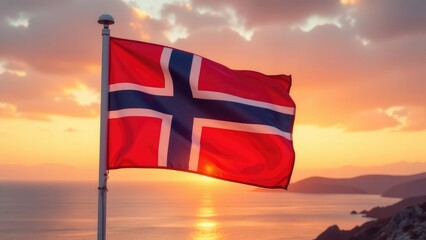 The Norwegian flag flies majestically against a vibrant sunset over the ocean.

