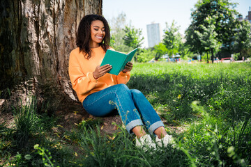 Photo of adorable sweet lady wear orange sweater enjoying reading book outdoors urban city park