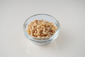 Shelled Pine Nuts: Close-Up of Roasted Siberian Seeds on a White Background