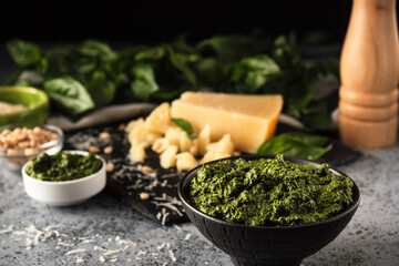Homemade Pesto Sauce with Pine Nuts and Basil: Ingredients on Black Background