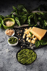 Homemade Pesto Sauce with Pine Nuts and Basil: Ingredients on Black Background