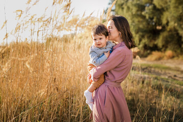 Portrait of happy loving mother and her baby son outdoors