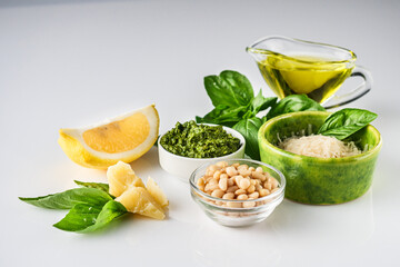 Homemade Pesto Sauce with Pine Nuts and Basil: Ingredients on White Background