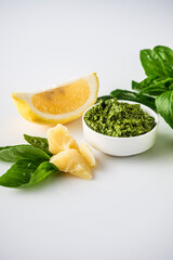 Homemade Pesto Sauce with Pine Nuts and Basil: Ingredients on White Background