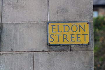 Street name sign for Eldon Street on a sandstone wall in Greenock Scotland 