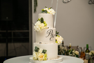 Large wedding ,white cake with initials and flowers