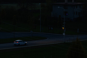 Speedometer pointer on a pole with a camera in the evening.
