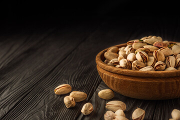 Cracked Pistachios: Healthy, Crunchy Nuts on Wooden and Black Backgrounds