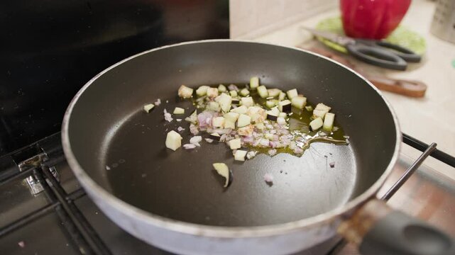 Frying Small Diced Onions In A Pan Of A Kitchen