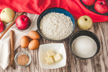 Ingredients Charlotte: A Delicious Apple Pie with Cinnamon on a Wooden Table