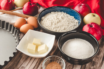 Ingredients Charlotte: A Delicious Apple Pie with Cinnamon on a Wooden Table
