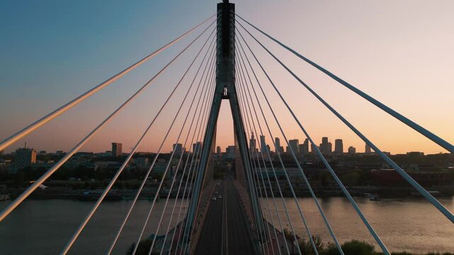 modern metal cable bridge over Vistula river at sunset, contemporary geometric architecture, cable-stayed bridge at city skyline, symmetry and architectural urban contrast, Warsaw 4k