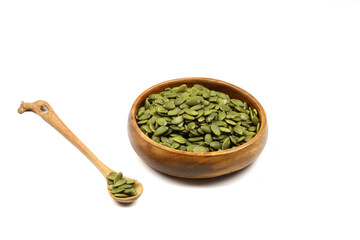 Pumpkin seeds in a wooden bowl on a white background