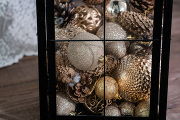 Elegant Collection of Golden Christmas Ornaments in a Lantern