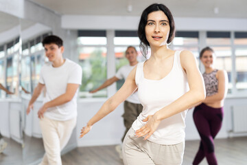 Girl, together with dance youth group, rehearses performance, works out succession of events...