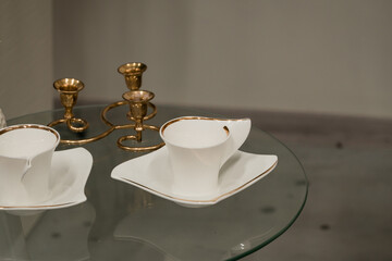Elegant White Porcelain Tea Set with Gold Accents and Candle Holders