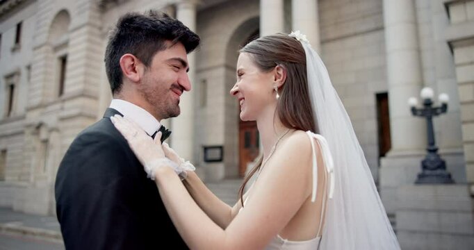 Couple, kissing and marriage at city hall with loyalty, commitment and wedding celebration outdoor. Bride, groom and happy people by courthouse for civil union, love ceremony or romantic relationship