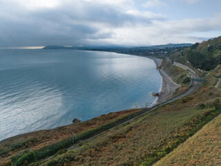 irish coastline at killiney with beach and railway line