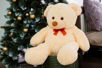 Cozy Holiday Teddy Bear Amidst a Festive Christmas Tree