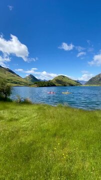 Scenic view of Moke Lake and tourists kayaking in the lake ,Queenstown, New Zealand 