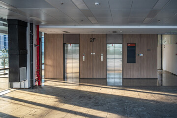 Modern Elevator Lobby in Commercial Building with Natural Light and Wood Accents