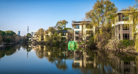 Peaceful Lakefront View with Lush Greenery and Architecture