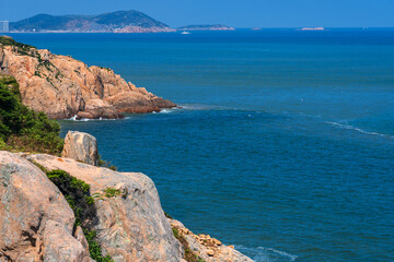 Serene Coastal View with Rocky Shores and Azure Waters