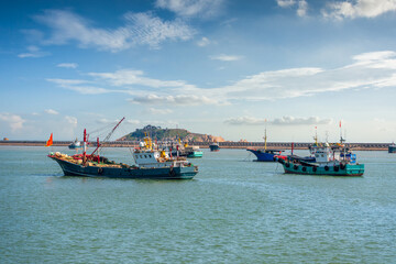 Obraz premium Scenic View of Fishing Boats Navigating Calm Waters