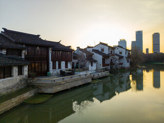 Naklejka premium Tranquil Riverfront Scene at Twilight with Historic and Modern Architecture