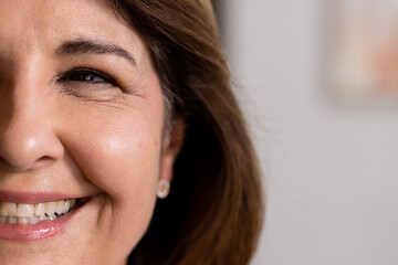 Close-up of senior woman smiling warmly, showcasing joy and happiness, at home, copy space