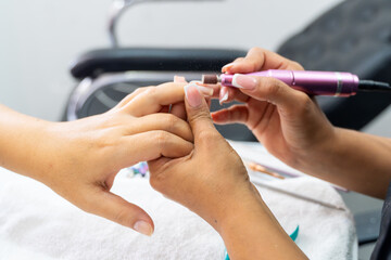 Latin Colombian manicurist doing nail cleaning and design. Beauty and fashion. Entrepreneurship.