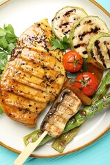 Delicious grilled vegetables and chicken breast on light blue wooden table, top view
