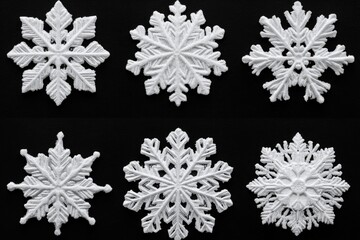 Black and white image of intricately designed snowflake ornaments arranged in a grid showcasing the unique patterns and delicate structure of each frosty flake against a dark background