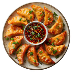 A plate of pork dumplings with a side of spicy soy dipping sauce and green onion garnish. Isolated on White Background 