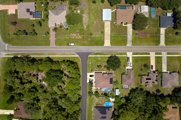 Aerial view of american small town in Florida with private homes between green palm trees and...
